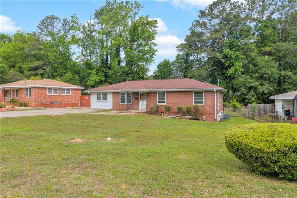1620 Rock Cut Road Conley, GA 30288 - Photo 2 of 43 a front view of a house with a garden