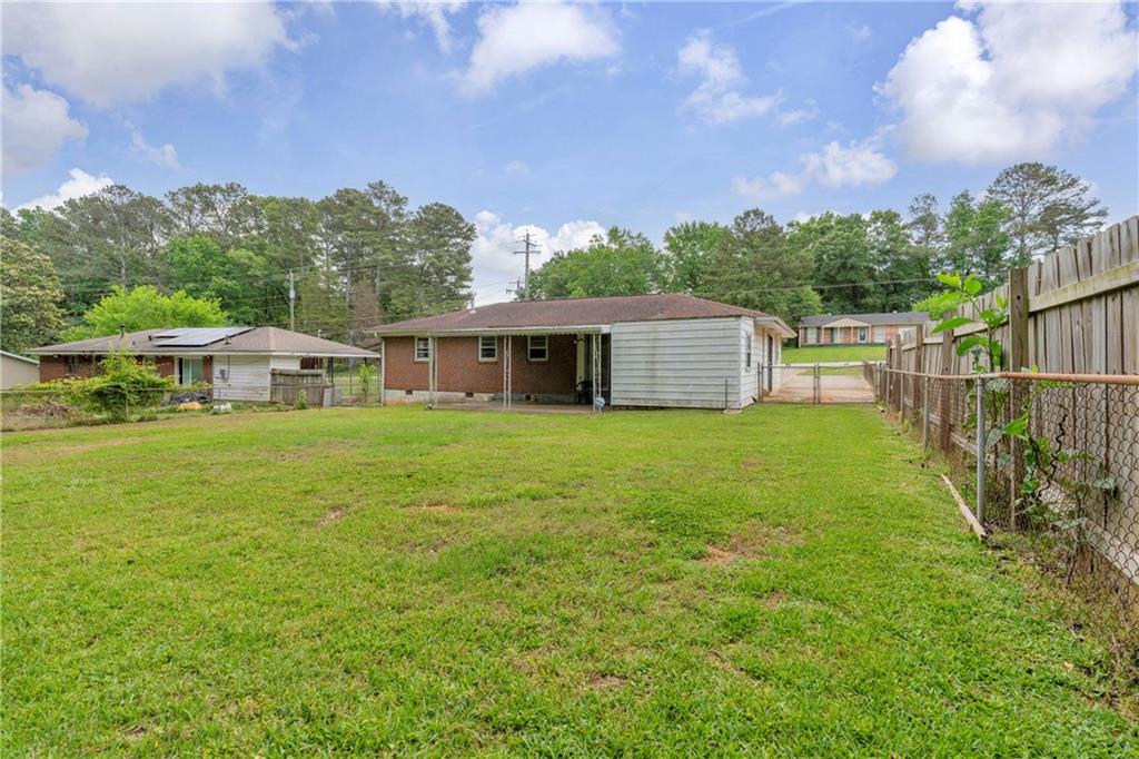 1620 Rock Cut Road Conley, GA 30288 - Photo 32 of 43 a view of a house with backyard and garden