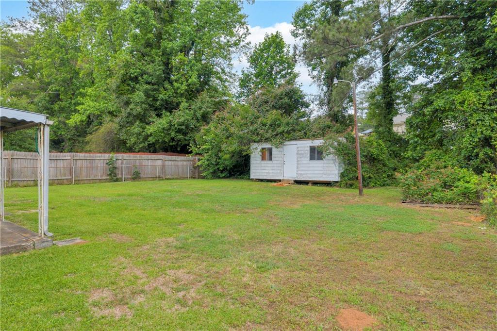 1620 Rock Cut Road Conley, GA 30288 - Photo 36 of 43 a view of a house with backyard and a garden
