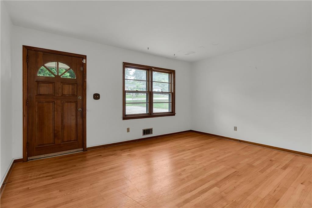 1620 Rock Cut Road Conley, GA 30288 - Photo 6 of 43 an empty room with wooden floor and windows