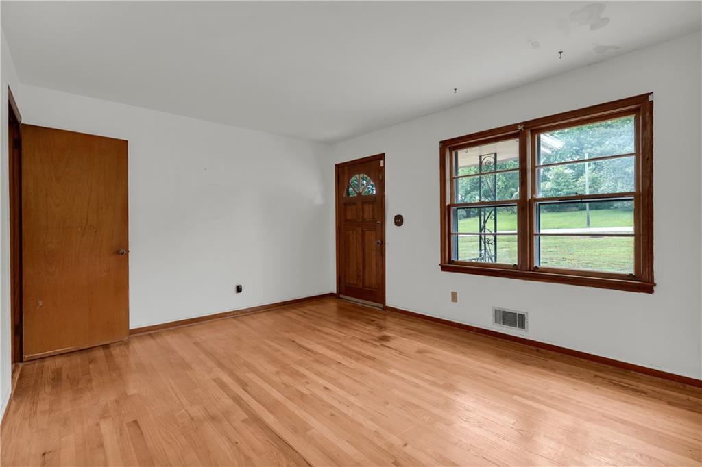 1620 Rock Cut Road Conley, GA 30288 - Photo 7 of 43 a view of an empty room with wooden floor and a window