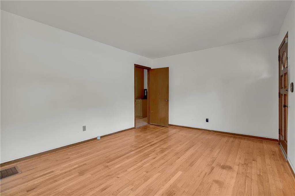 1620 Rock Cut Road Conley, GA 30288 - Photo 8 of 43 a view of an empty room with wooden floor and a window
