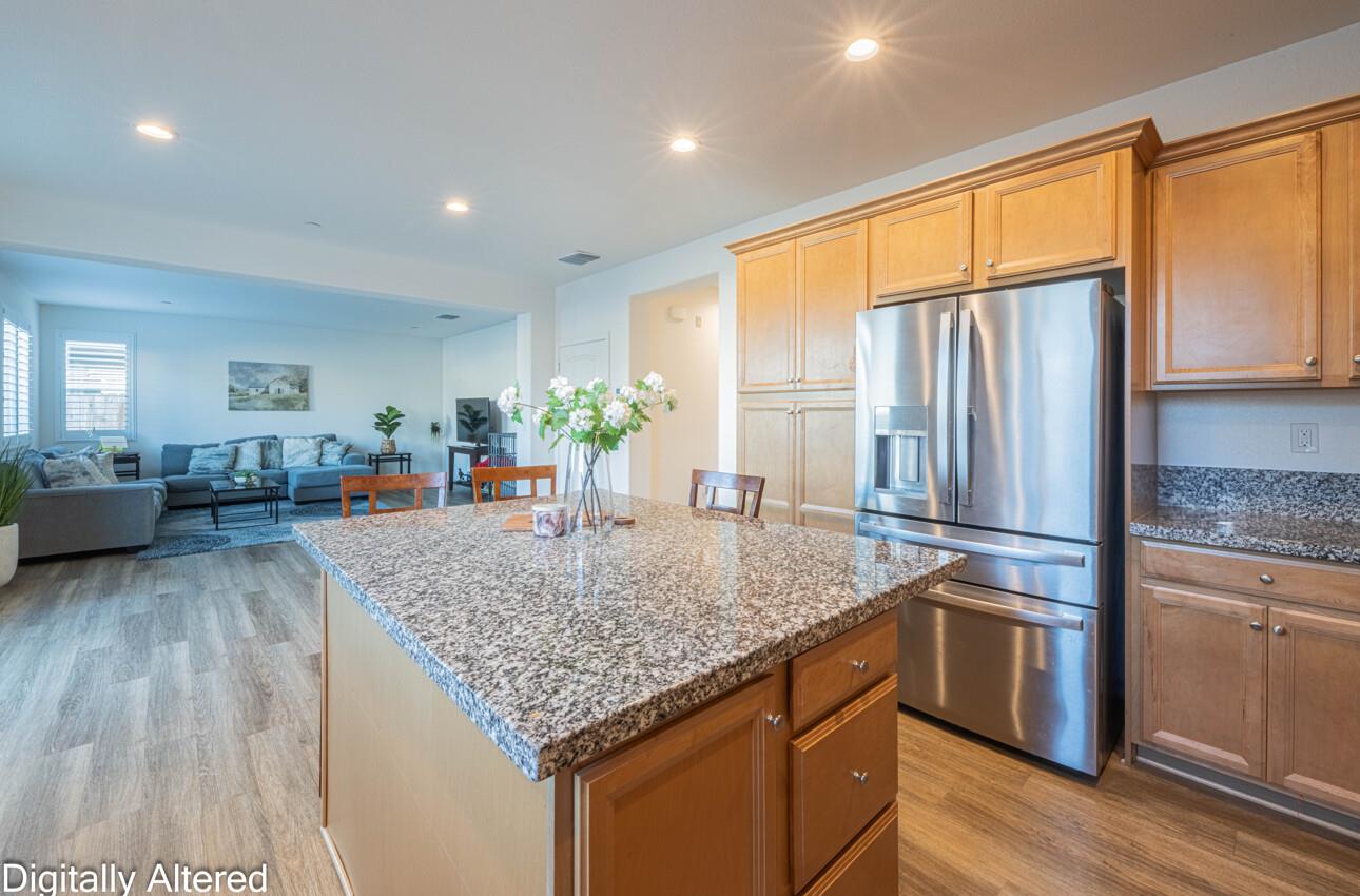 570 Tankersley Street Soledad, CA 93960 - Photo 19 of 64 a kitchen with stainless steel appliances granite countertop sink refrigerator and microwave