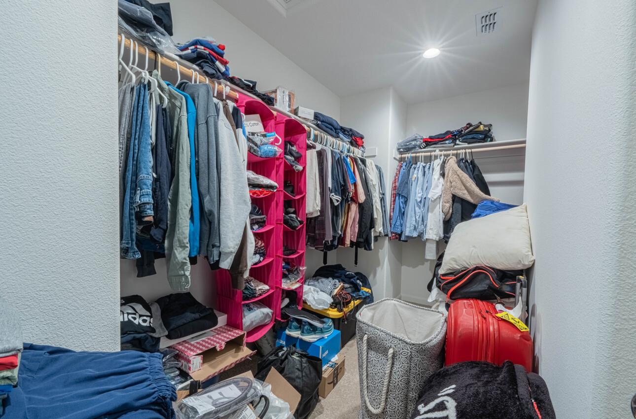 570 Tankersley Street Soledad, CA 93960 - Photo 48 of 64 a view of walk in closet with clothes and shoes