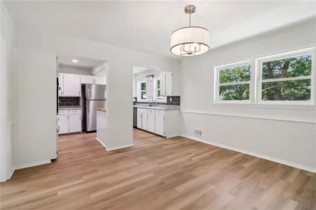 a kitchen with stainless steel appliances granite countertop a refrigerator sink and cabinets