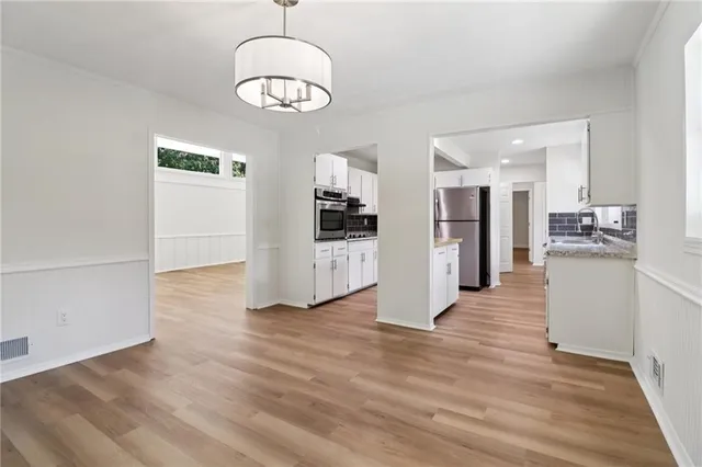 a kitchen with stainless steel appliances granite countertop a sink and a stove