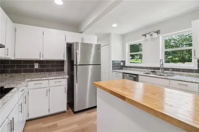a bathroom with a sink a mirror and a shower