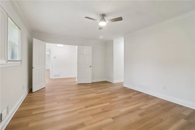 a view of a hallway with wooden floor and staircase