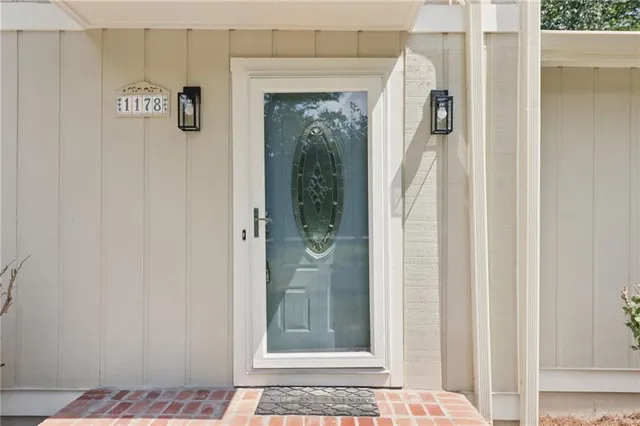 a view of a hallway with wooden floor and a livingroom