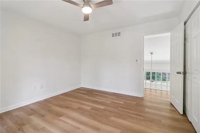 a view of a house with backyard and trees