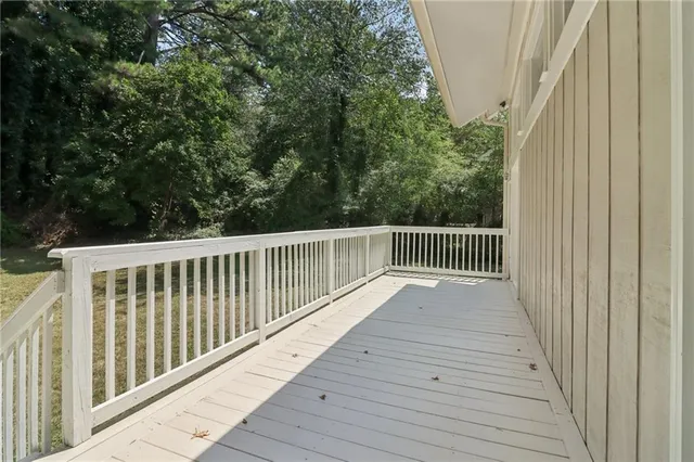 a view of swimming pool on a sunny day with lawn chairs