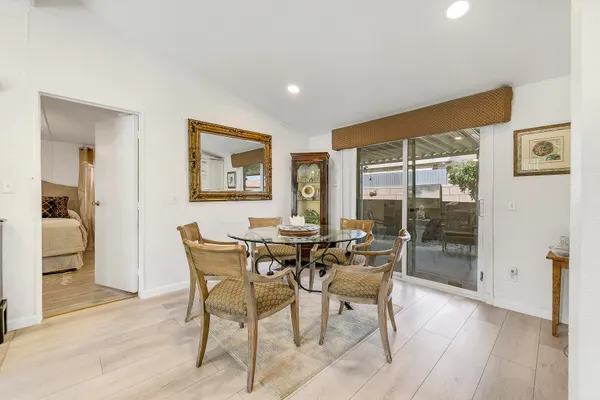a dining room with furniture and wooden floor