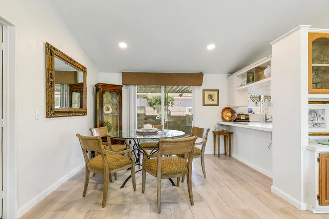 a dining room with furniture and a window