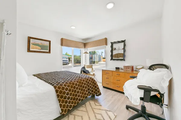 a bedroom with a large bed and a large window