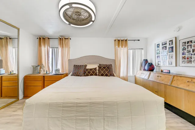 a view of a patio with table and chairs under an umbrella