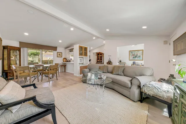 a living room with furniture and potted plants