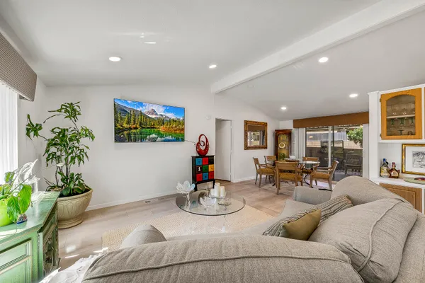 a living room with furniture and a kitchen view
