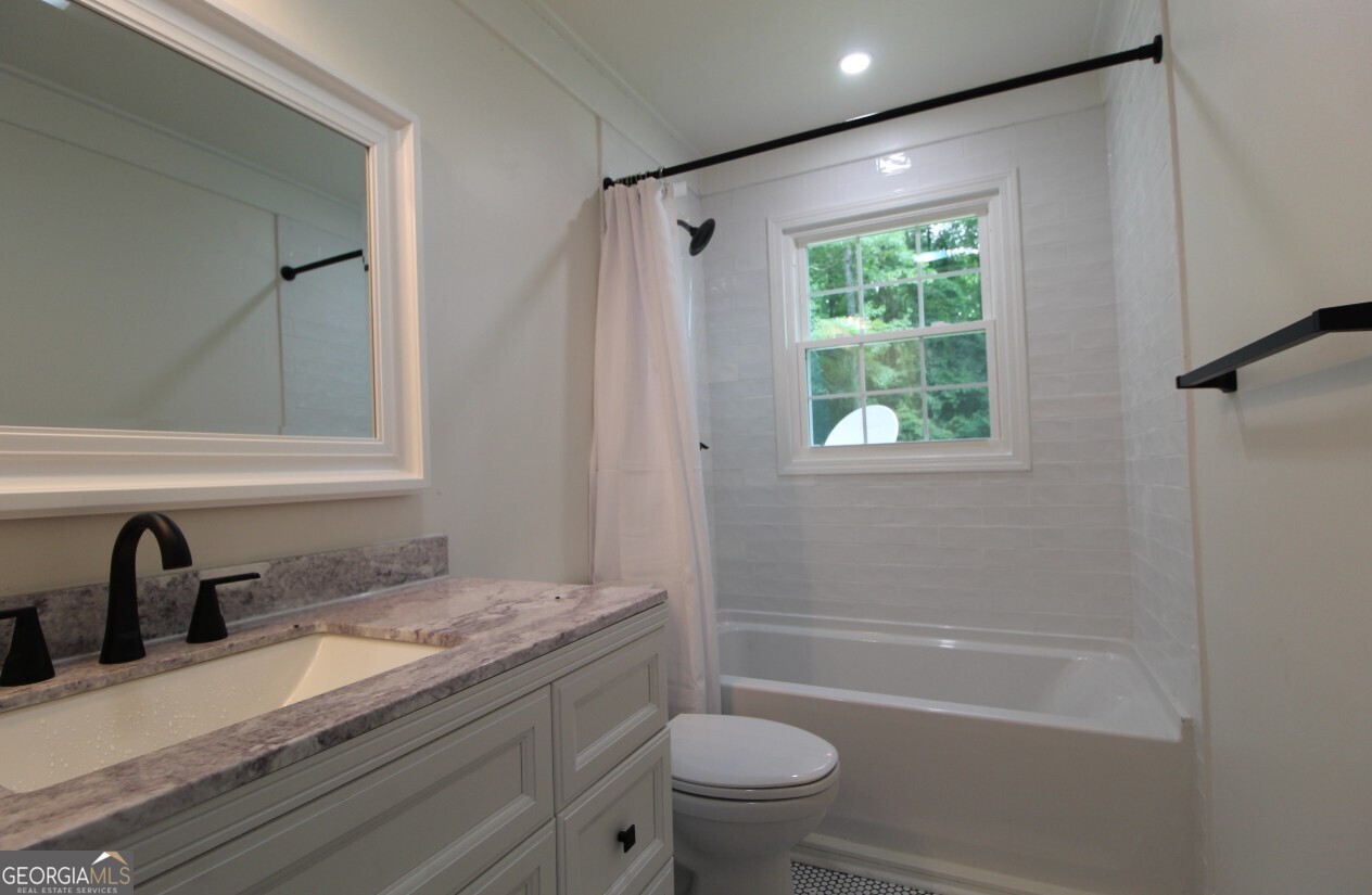 8142 Alabama Highway Rome, GA 30165 - Photo 7 of 10 a bathroom with a granite countertop sink toilet and shower