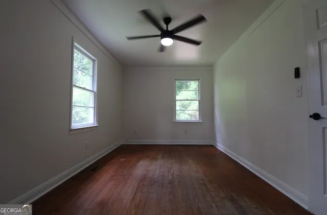 wooden floor in an empty room with a window