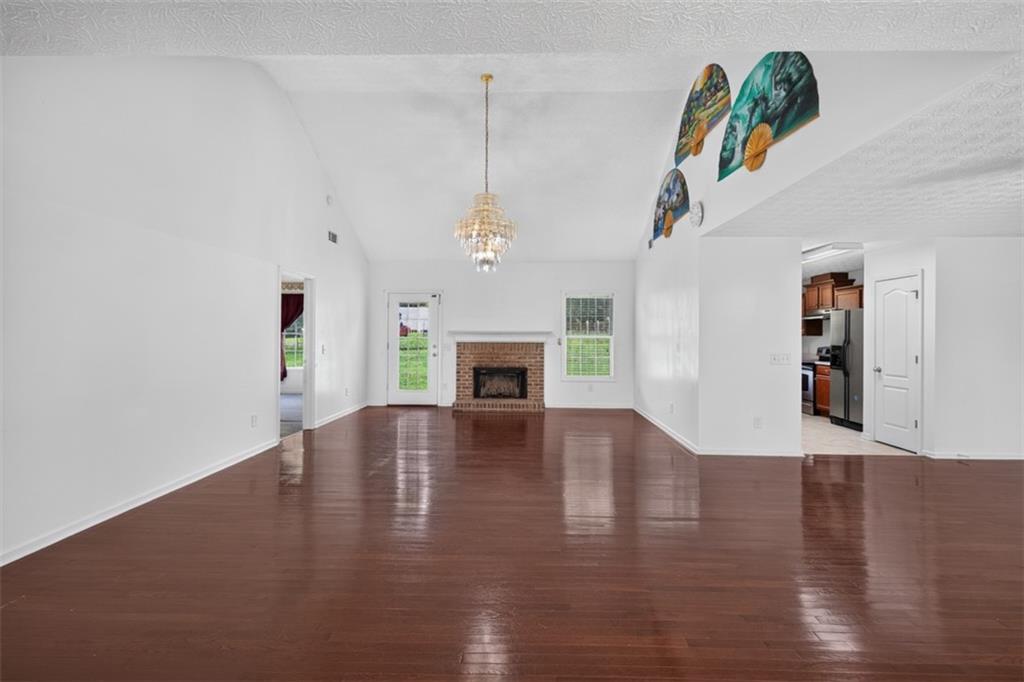 602 Pendergrass Road Winder, GA 30680 - Photo 10 of 44 a view of a livingroom with wooden floor and a ceiling fan