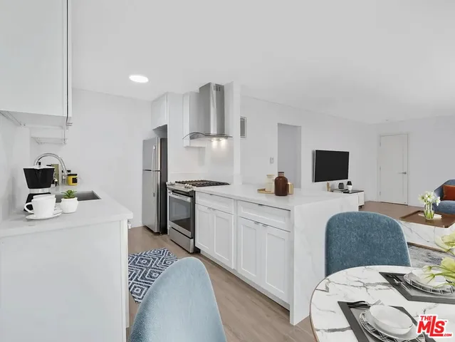 a kitchen with a sink appliances and cabinets