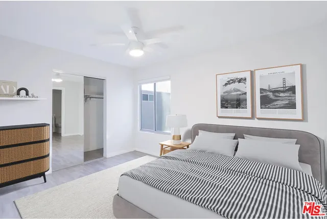 a bedroom with a large bed and a chandelier