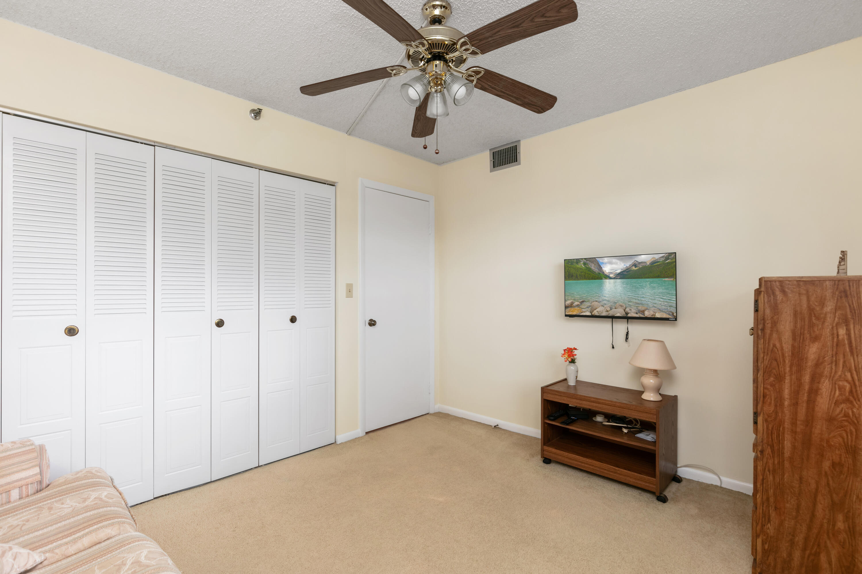 9235 Southwest 8th Street, Unit 407 Boca Raton, FL 33428 - Photo 17 of 24 a bedroom with furniture and a window