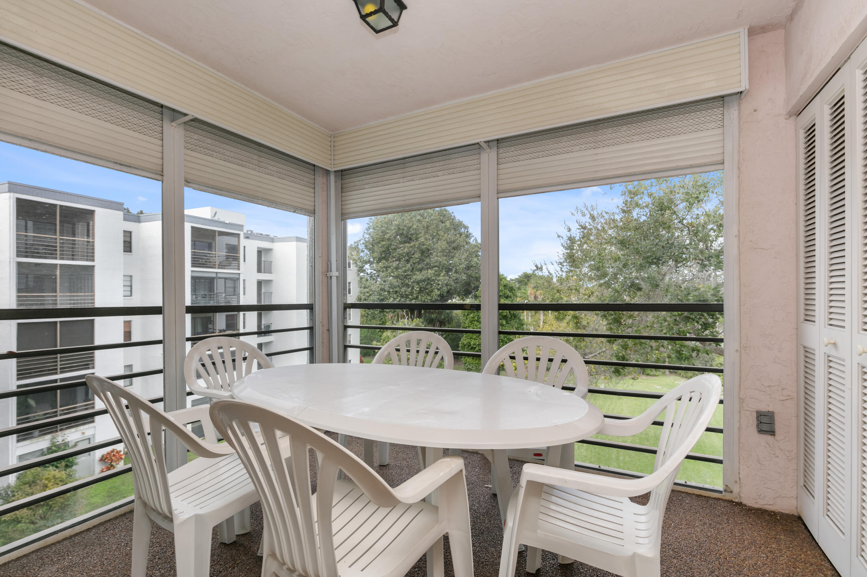 9235 Southwest 8th Street, Unit 407 Boca Raton, FL 33428 - Photo 3 of 24 a view of a city from a dining room with furniture window and wooden floor