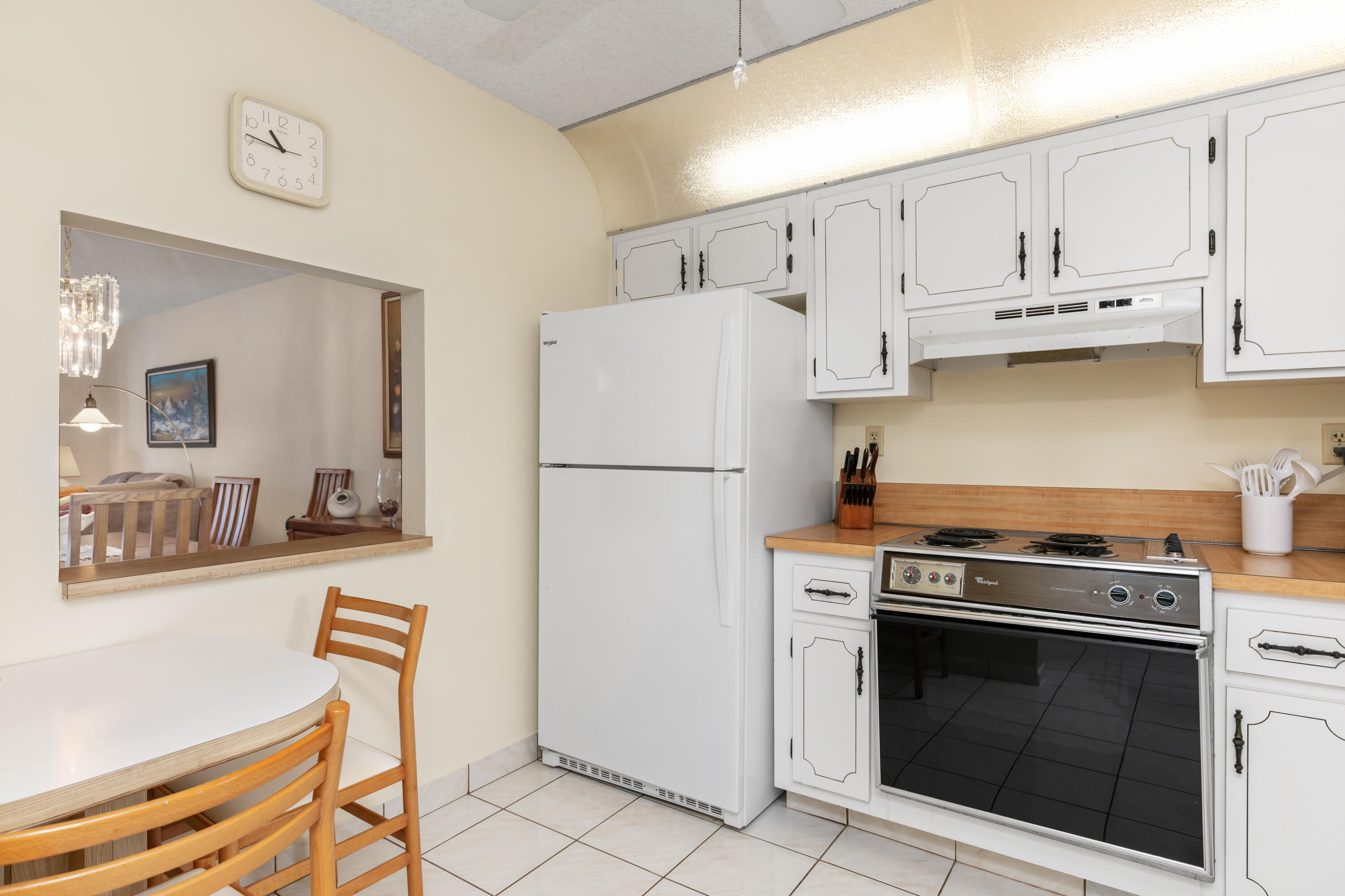 9235 Southwest 8th Street, Unit 407 Boca Raton, FL 33428 - Photo 7 of 24 a kitchen with stainless steel appliances granite countertop a stove a refrigerator and a refrigerator with white cabinets
