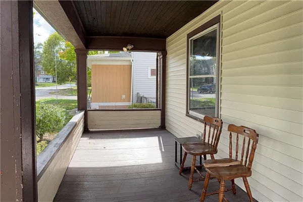 a view of a porch with furniture and a yard
