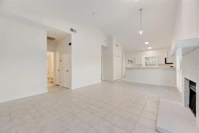 a view of a kitchen with a sink and a refrigerator in it