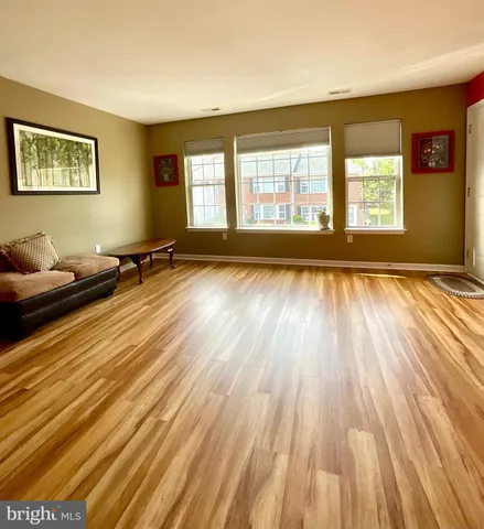 a view of a room with wooden floor and windows
