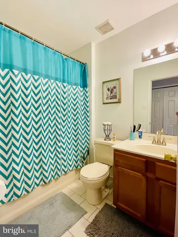 a bathroom with a sink toilet and mirror