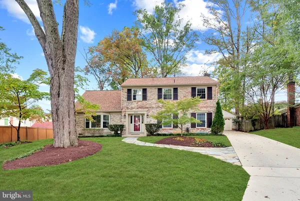 a front view of a house with yard and green space