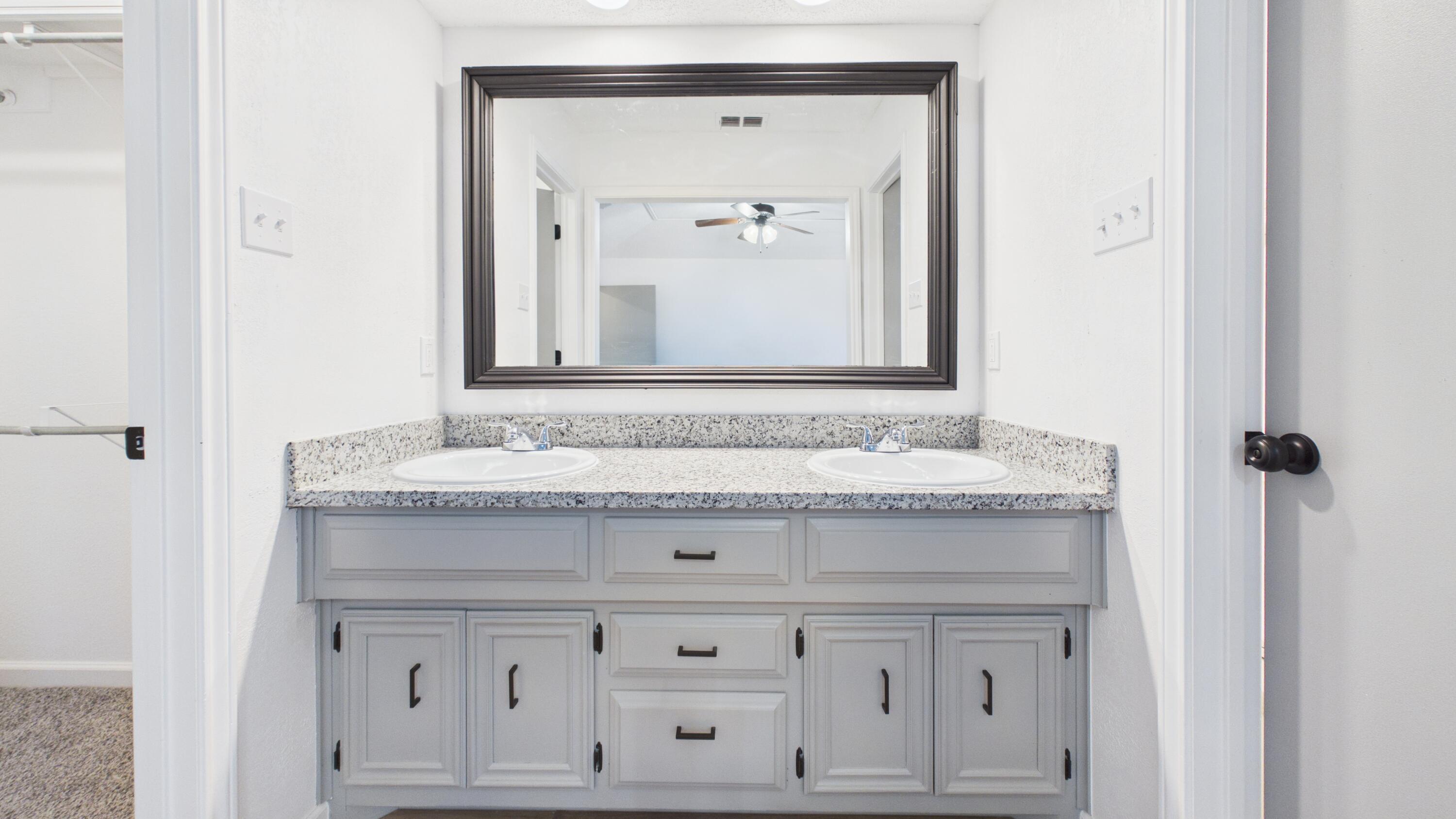 6902 Homestead Avenue Lubbock, TX 79424 - Photo 15 of 17 a view of a sink vanity and mirror