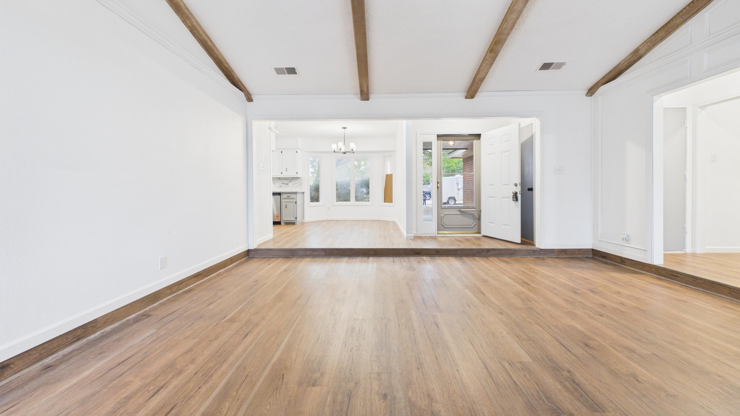 6902 Homestead Avenue Lubbock, TX 79424 - Photo 3 of 17 an empty room with wooden floor and windows