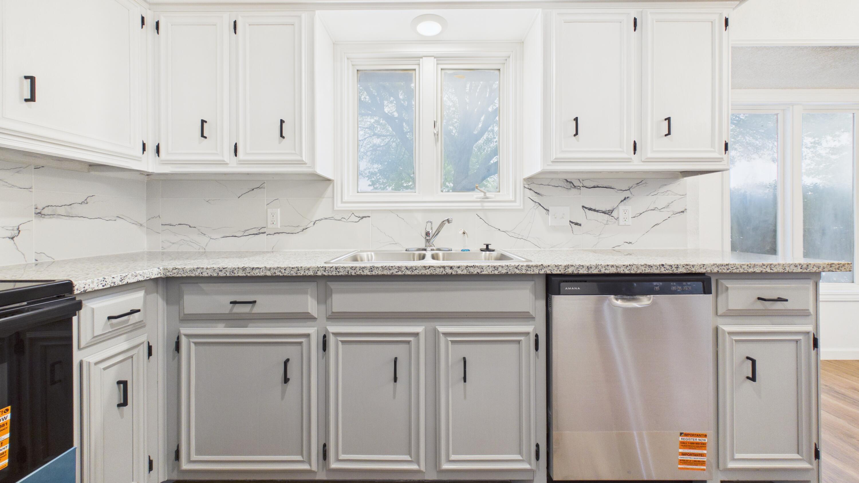 6902 Homestead Avenue Lubbock, TX 79424 - Photo 5 of 17 a kitchen with granite countertop white cabinets and a sink