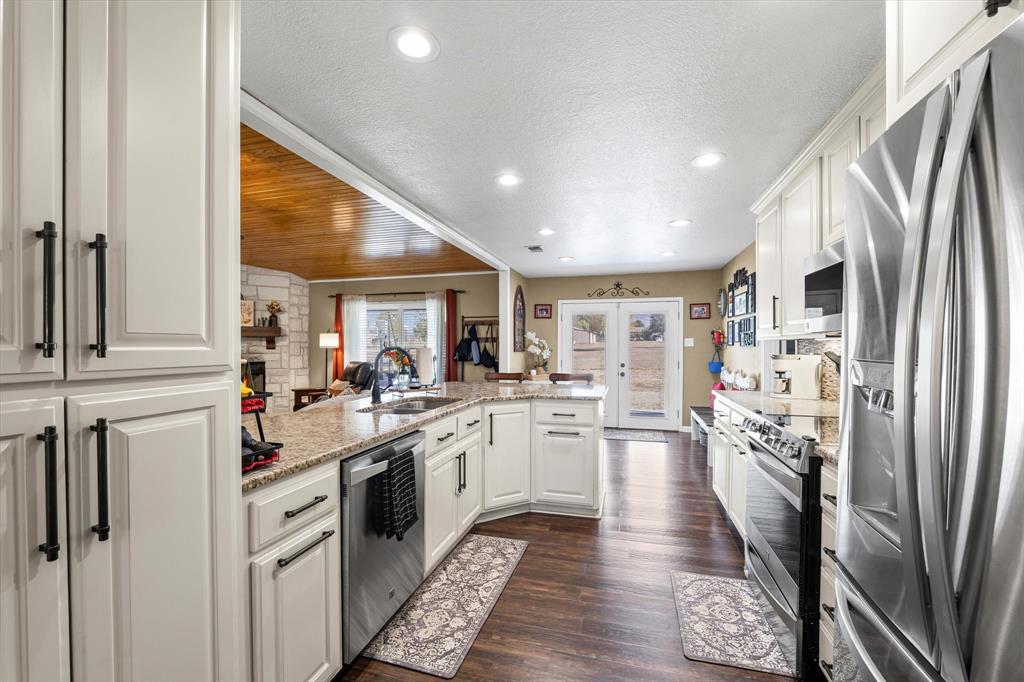 134 Thiele Road Lorena, TX 76655 - Photo 16 of 37 a kitchen with white cabinets and stainless steel appliances