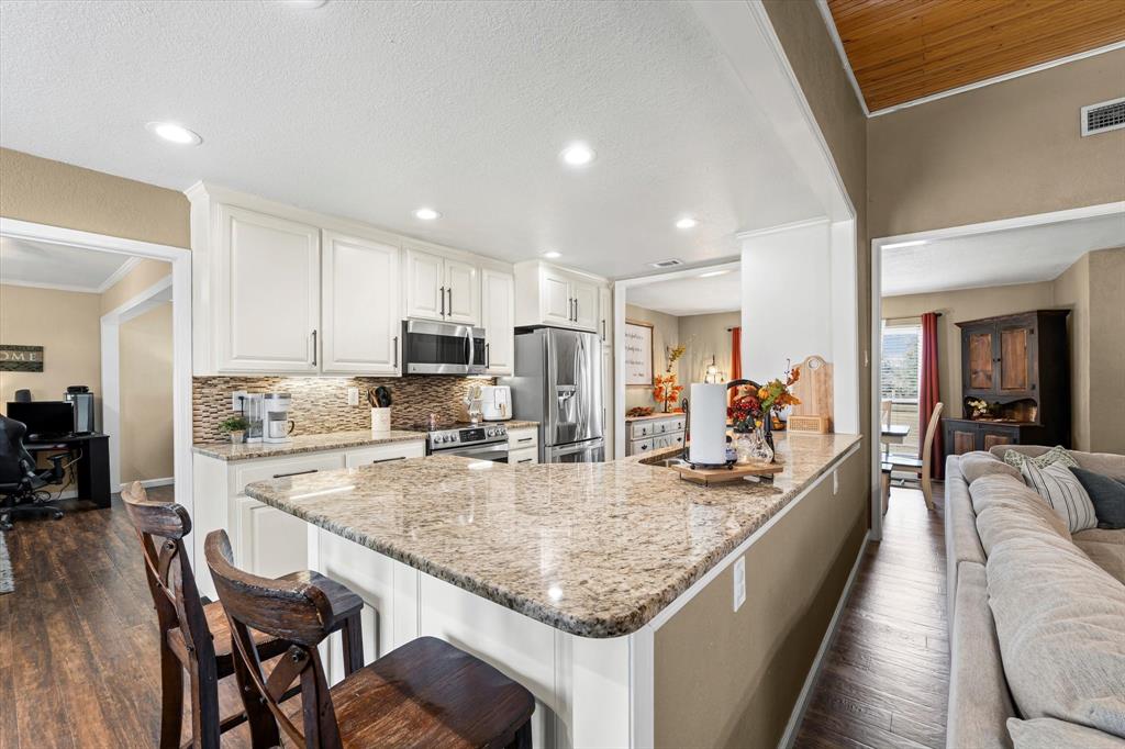 134 Thiele Road Lorena, TX 76655 - Photo 17 of 37 a large kitchen with granite countertop lots of counter space and stainless steel appliances