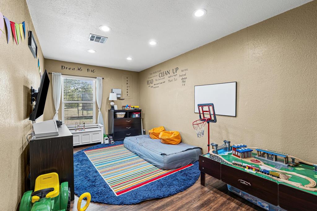 134 Thiele Road Lorena, TX 76655 - Photo 25 of 37 a bedroom with a bed and wooden floor