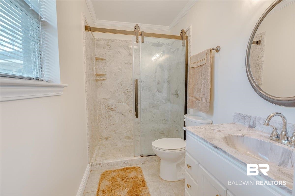 440 Dykes Road Mobile, AL 36608 - Photo 26 of 49 Bathroom featuring a stall shower, toilet, and crown molding
