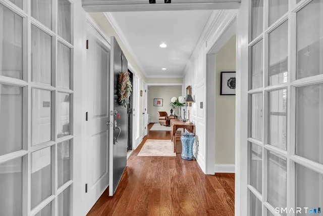a living room with furniture flowerpot and wooden floor