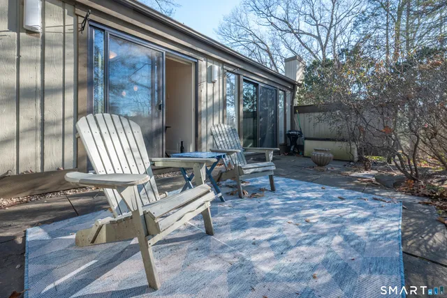 a backyard of a house with outdoor seating