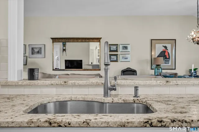a kitchen with a sink and a stove top oven