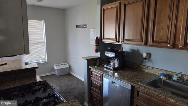 a kitchen with a sink and a stove top oven