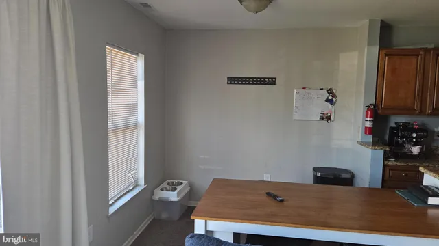 a view of a kitchen with a table and a window