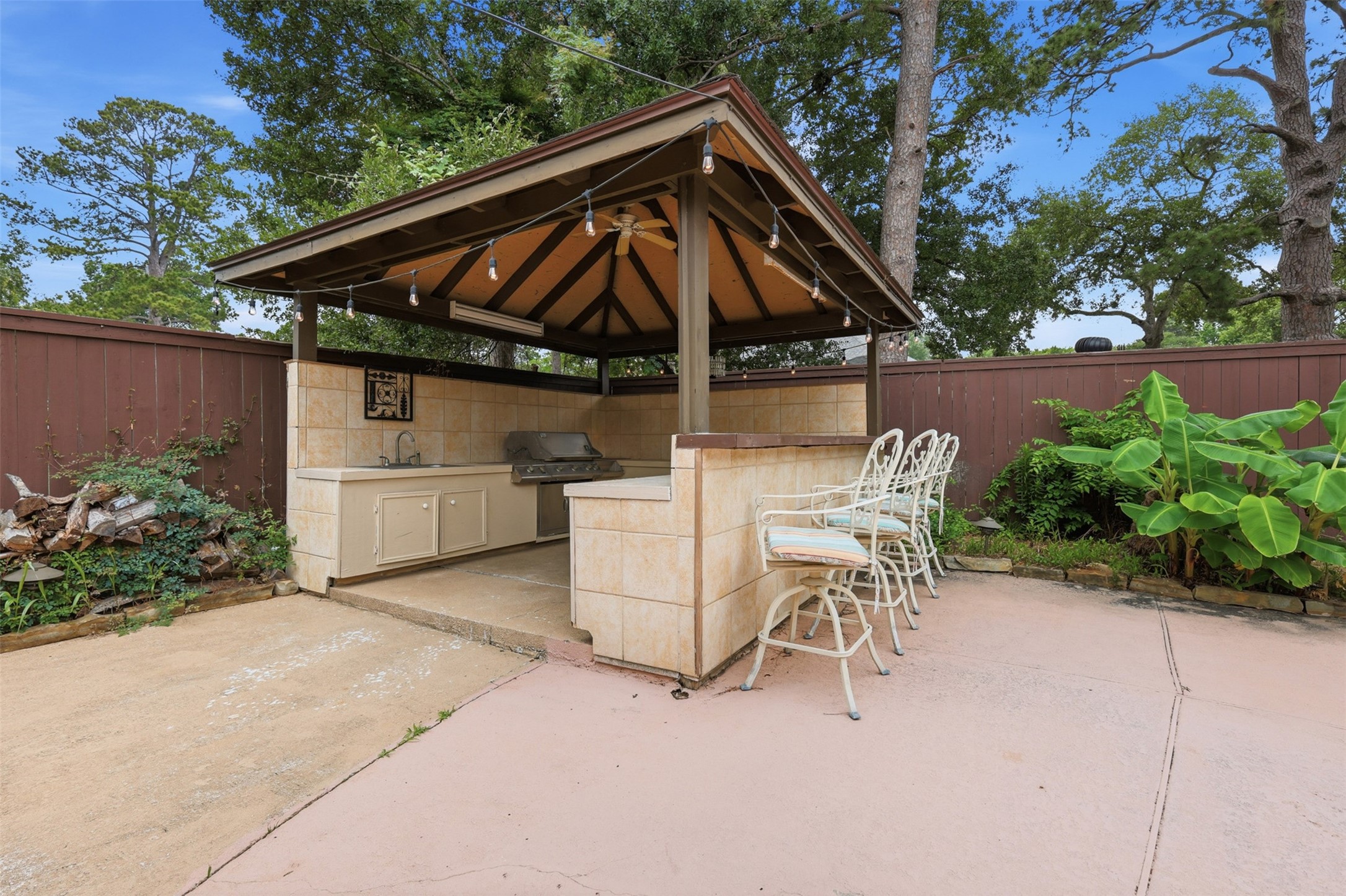 7010 River Mill Drive Spring, TX 77379 - Photo 24 of 29 a patio with a table and chairs under an umbrella