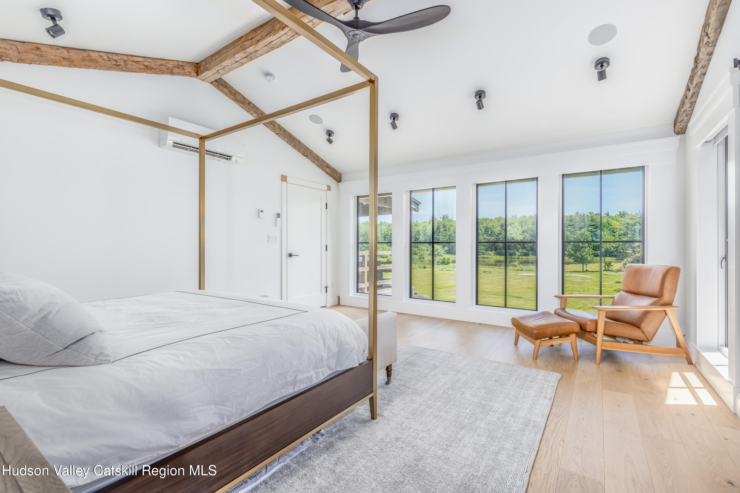 688 Bruce Porn Road Gilboa, NY 12167 - Photo 4 of 104 a spacious bedroom with a bed couch and a large window
