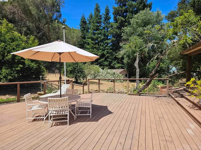 a view of house with wooden floor and outdoor seating