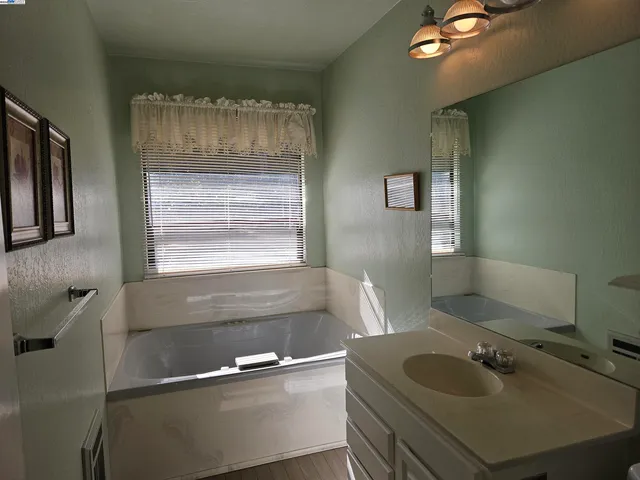 a view of empty room with windows and ceiling fan